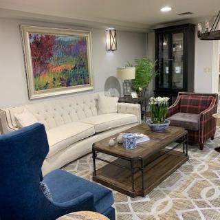 A cozy living room with elegant furniture and colorful artwork.