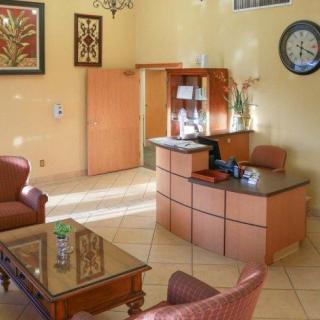 A cozy hotel lobby with a reception desk and comfortable seating.