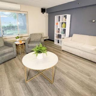 A modern and cozy living room featuring comfortable seating and a bright atmosphere.