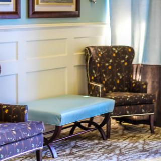 Cozy seating arrangement featuring patterned armchairs and a stylish ottoman.