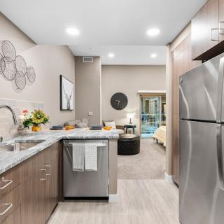 A modern kitchen with stainless steel appliances and stylish decor.