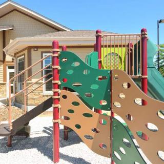 A colorful playground with slides and climbing equipment on a sunny day.