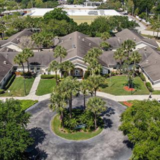 Aerial view of a residential building surrounded by trees.