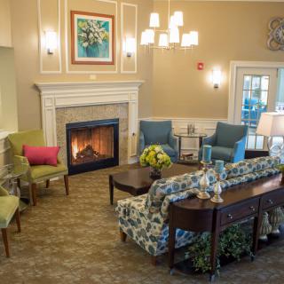 A cozy living room with a fireplace and comfortable seating.