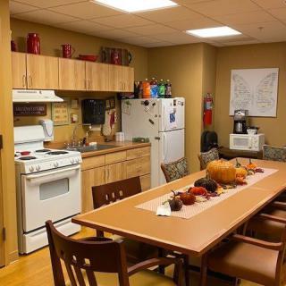 A cozy kitchen and dining area with autumn-themed decorations on the table.