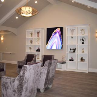 A modern living room with comfortable seating, decorative shelves, and stylish lighting.