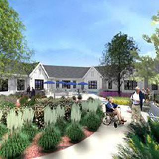 A serene garden setting with people enjoying the outdoors near a building.