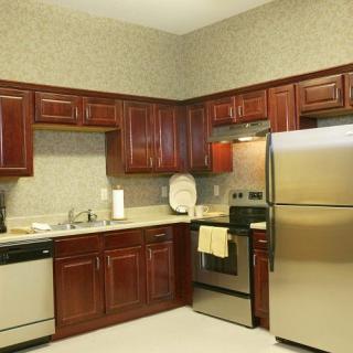 A modern kitchen with stainless steel appliances and wooden cabinets.