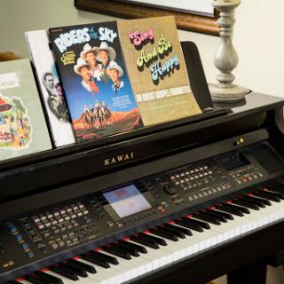 A stylish piano with music sheets for various performances.