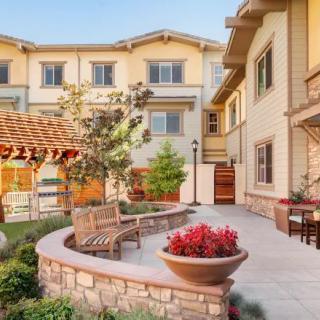 A picturesque courtyard featuring outdoor seating and vibrant landscaping.