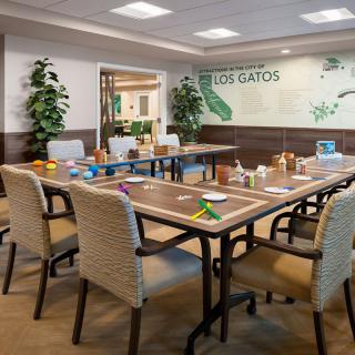 A well-arranged conference room with a large meeting table, chairs, and decorative plants.
