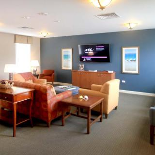 A cozy and modern living room with comfortable seating and a large television.