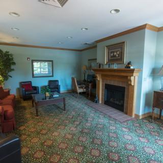 A cozy living room with a fireplace, comfortable seating, and decorative elements.