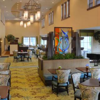 A spacious and elegantly decorated hotel lobby with seating arrangements and artwork.