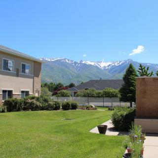 A serene view of a residential area with mountains in the background under a clear blue sky.