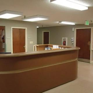 A reception desk area with overhead lighting and multiple doors.