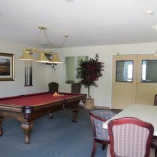 A recreational room featuring a pool table and seating area.