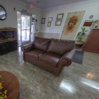 A cozy waiting room with a brown sofa, decorative elements, and a welcoming atmosphere.
