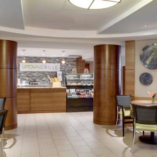 A modern cafe interior with a service counter and seating area.