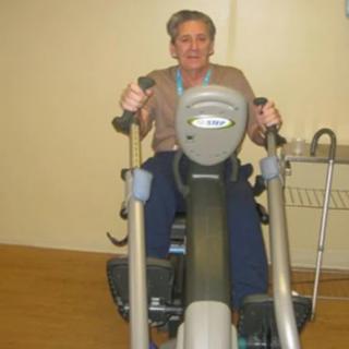 A person exercising on a cardio machine in a gym.