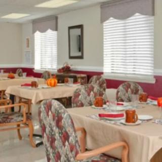 A neatly arranged dining area with tables and chairs set for a meal.