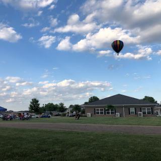 A colorful hot air balloon floats gracefully in the sky above a serene landscape.