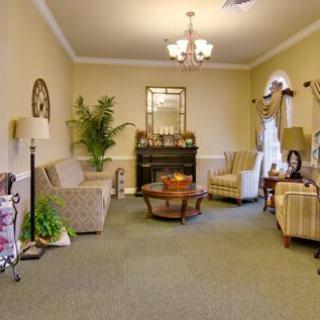 A cozy and elegantly furnished living room with sofas, armchairs, a coffee table, and decor elements.