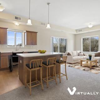 A modern open-concept kitchen and living room with an island counter and stylish decor.