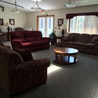 A cozy living room with several sofas and a coffee table arranged in a circular layout.