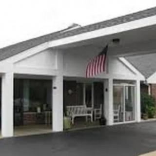 A building entrance with an American flag displayed above a covered area.