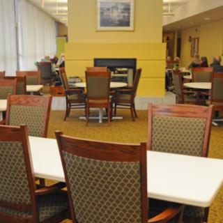 A quiet lounge area with tables and chairs, ideal for studying or relaxing.