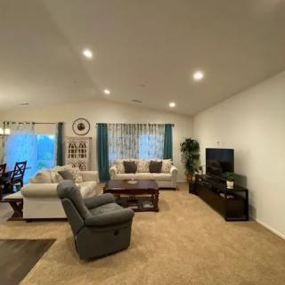 A cozy living room with comfortable seating and warm lighting.