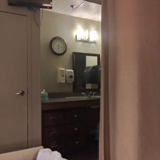 A glimpse of a hotel room with a view into the bathroom area.