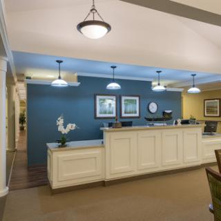 A modern reception area featuring a welcoming desk and stylish lighting.