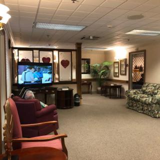 A cozy waiting area with comfortable seating and a television.
