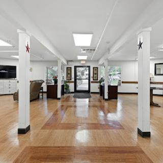 A welcoming lobby featuring wooden floors, bright lighting, and a modern aesthetic.