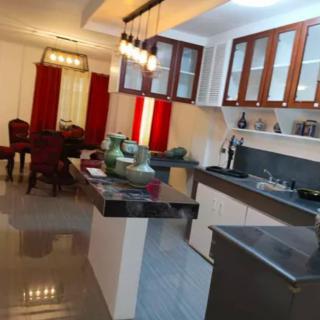 A modern kitchen with sleek countertops and a connected dining area.