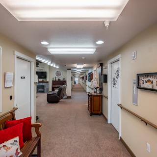 A well-lit hallway with seating and decor.