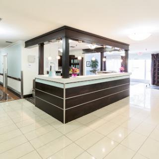 A modern hotel reception area featuring a sleek front desk and contemporary design elements.