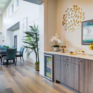 A modern living and dining area featuring wood flooring, stylish decor, and comfortable furnishings.