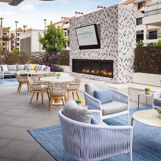 Modern outdoor patio with comfortable seating and a stylish fireplace.