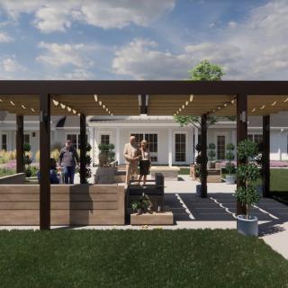 A beautifully landscaped backyard featuring a modern pergola and outdoor seating area.
