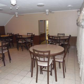An empty dining area with multiple tables and chairs arranged neatly.