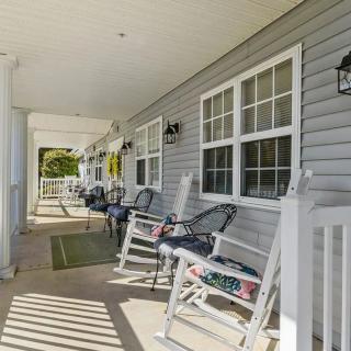 A cozy porch with rocking chairs and a view of the outdoors.