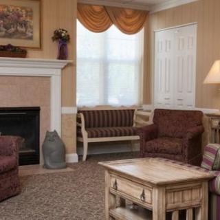 A cozy living room with a fireplace, sofas, and a coffee table.