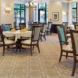 An elegant dining room with neatly arranged tables and chairs.