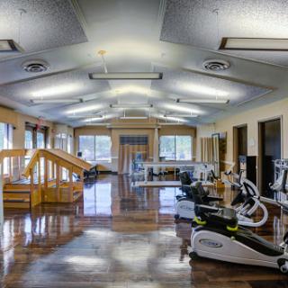 A spacious and well-equipped gym designed for fitness and rehabilitation.