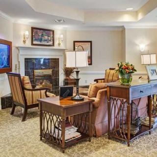 A cozy living room with comfortable seating and a warm fireplace.