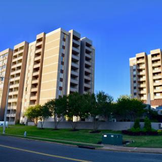 A view of modern residential buildings under a clear blue sky.
