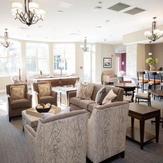 A spacious and elegantly decorated living room with comfortable seating and tasteful lighting.